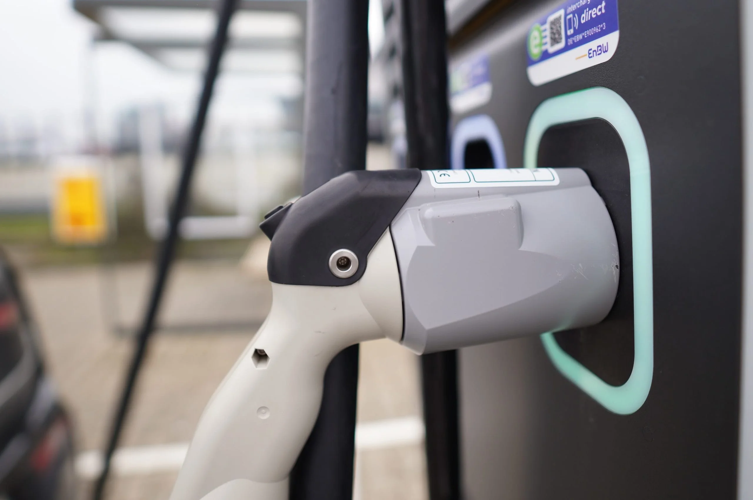 Close-up of an electric vehicle charger plugged in and charging